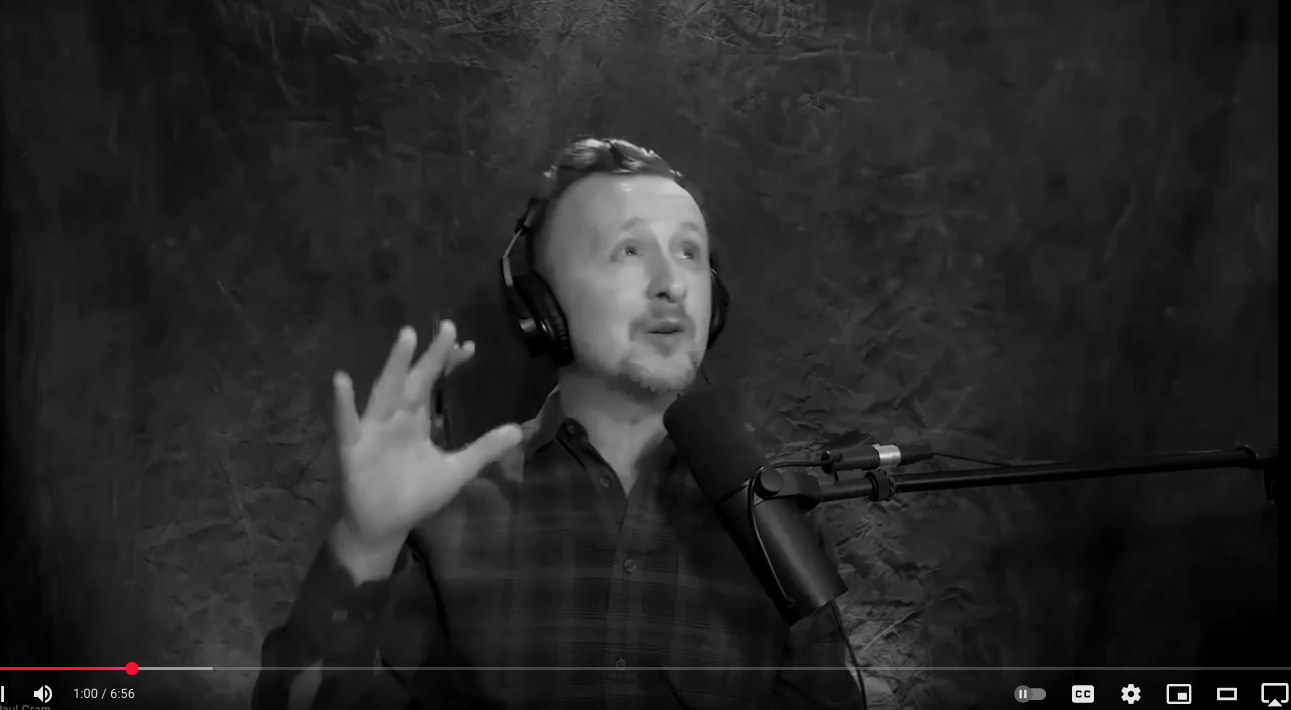 Actor Paul Cram looking towards the sky while talking into a microphone